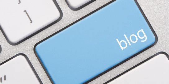 Close-up of a computer keyboard with a blue key labeled "5 Ways Guest Blogging Can Help Your Law Firm" replacing one of the standard keys.