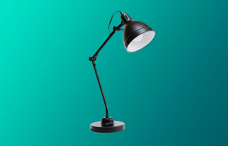 A black adjustable desk lamp with a round base and large conical shade, set against a teal gradient background.