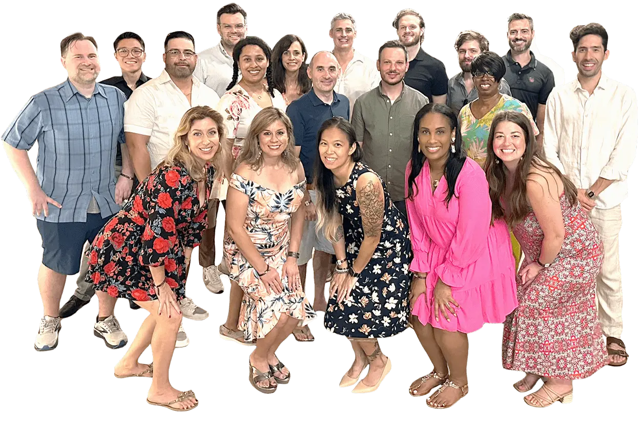 A diverse group of people standing and smiling, some in casual attire and others in floral and bright dresses. The background is removed.